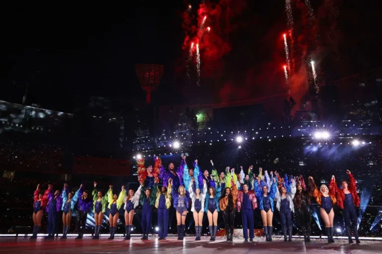 Taylor Swift performs on the Eras Tour stage with fireworks and dancers — the tour behind her record Eras Tour bonuses to crew